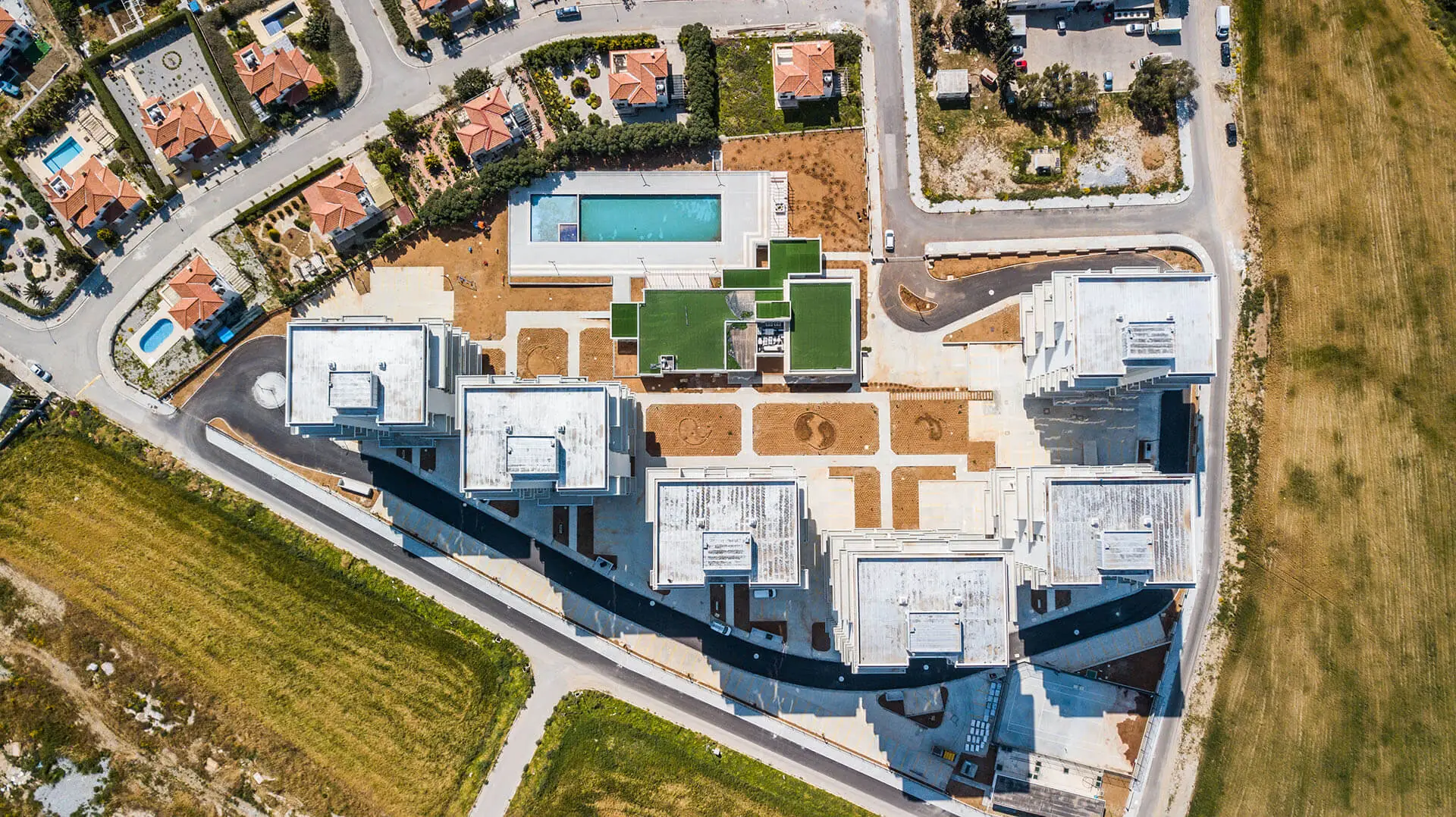 Abelia Residence seen from above, with the pool deck and gardens