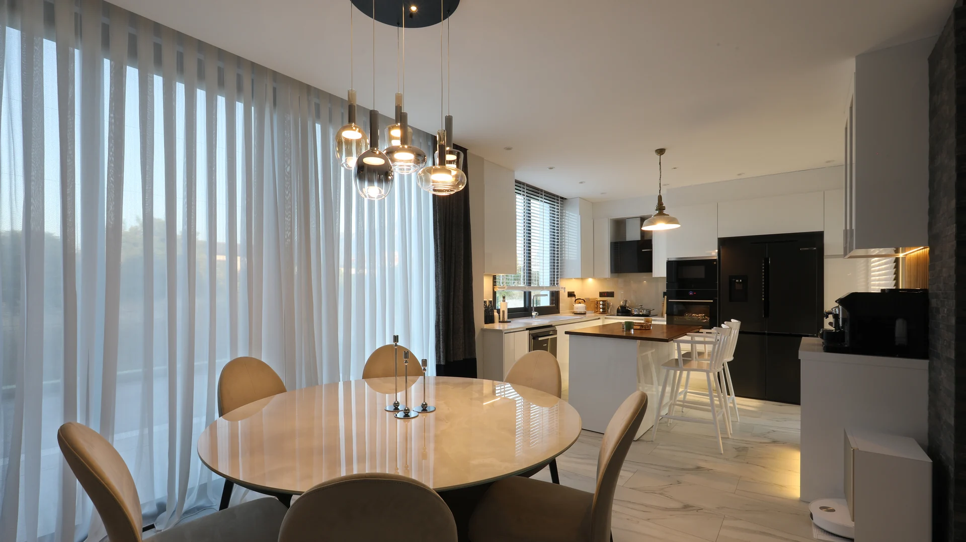 Dining table and open kitchen in an Azure villa