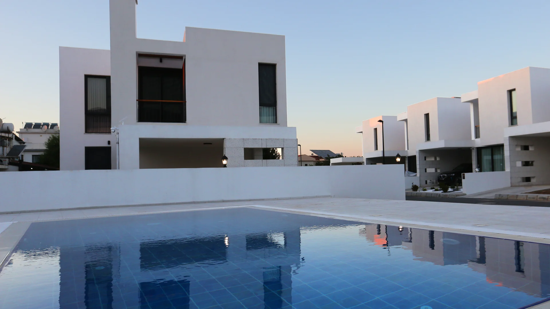 Azure villas reflected in the shared pool