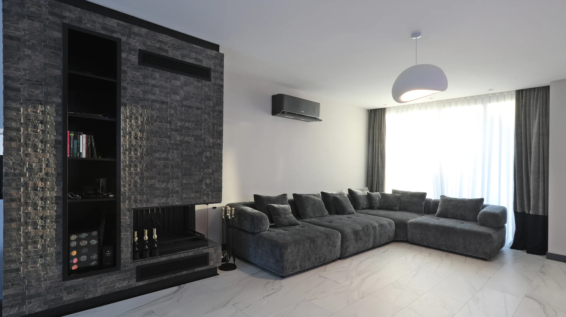 Living room with a stone clad feature wall in an Azure villa