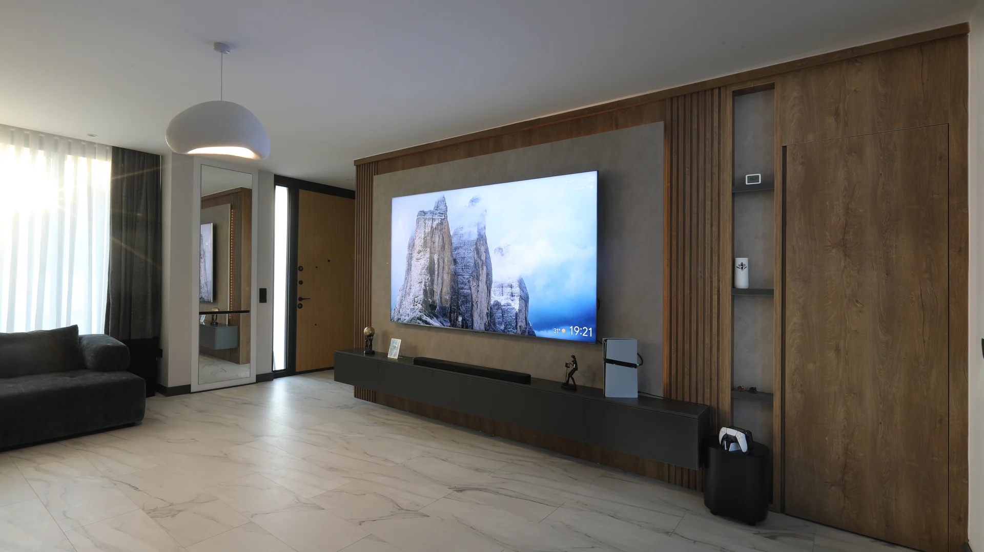 Living room with a wood panelled media wall in an Azure villa