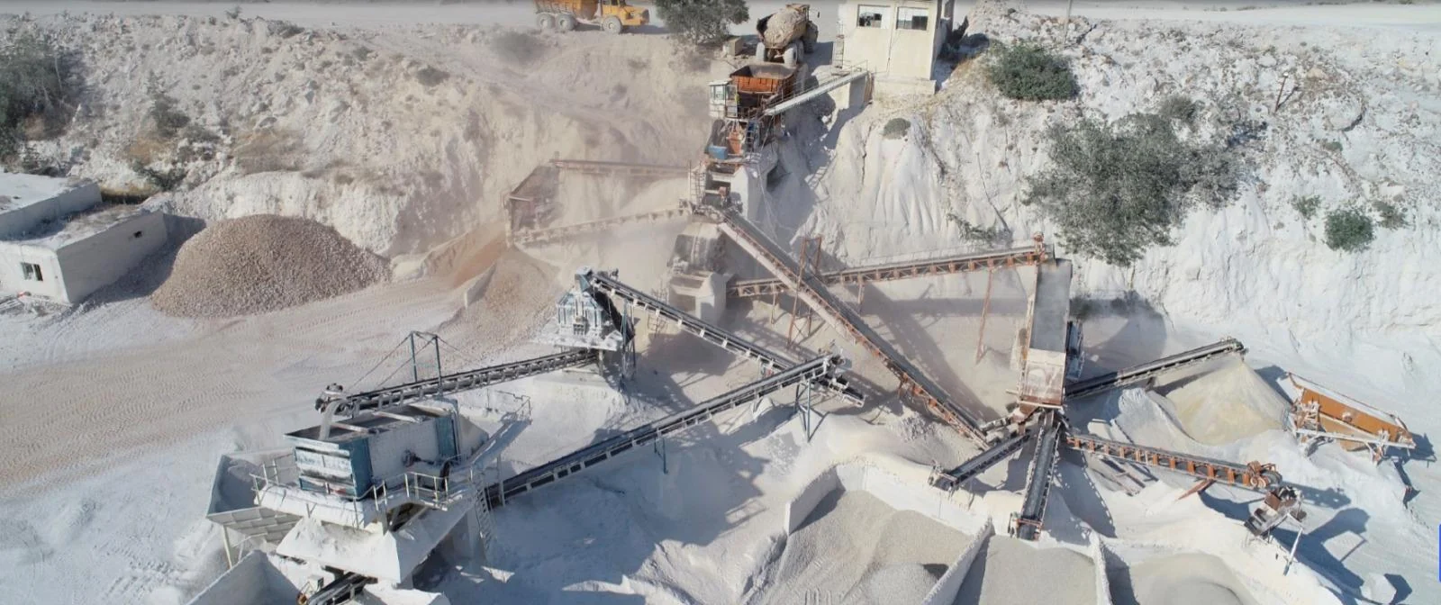 Aerial view of a limestone quarry and aggregate crushing plant with conveyors